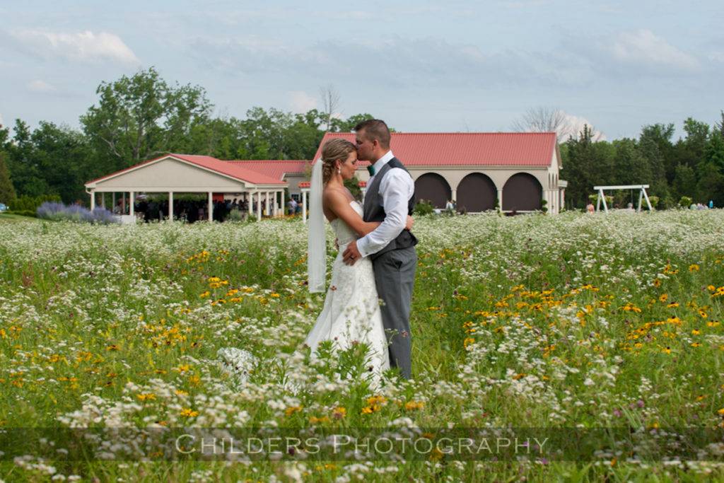 couple posing in wildflowers