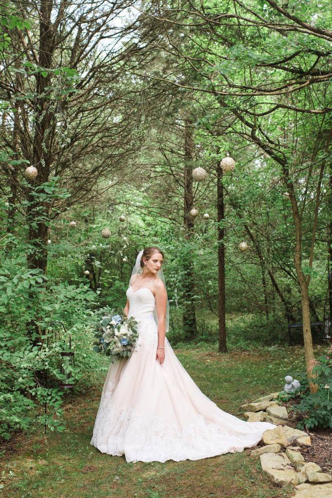 elegant bride posing in forest wedding
