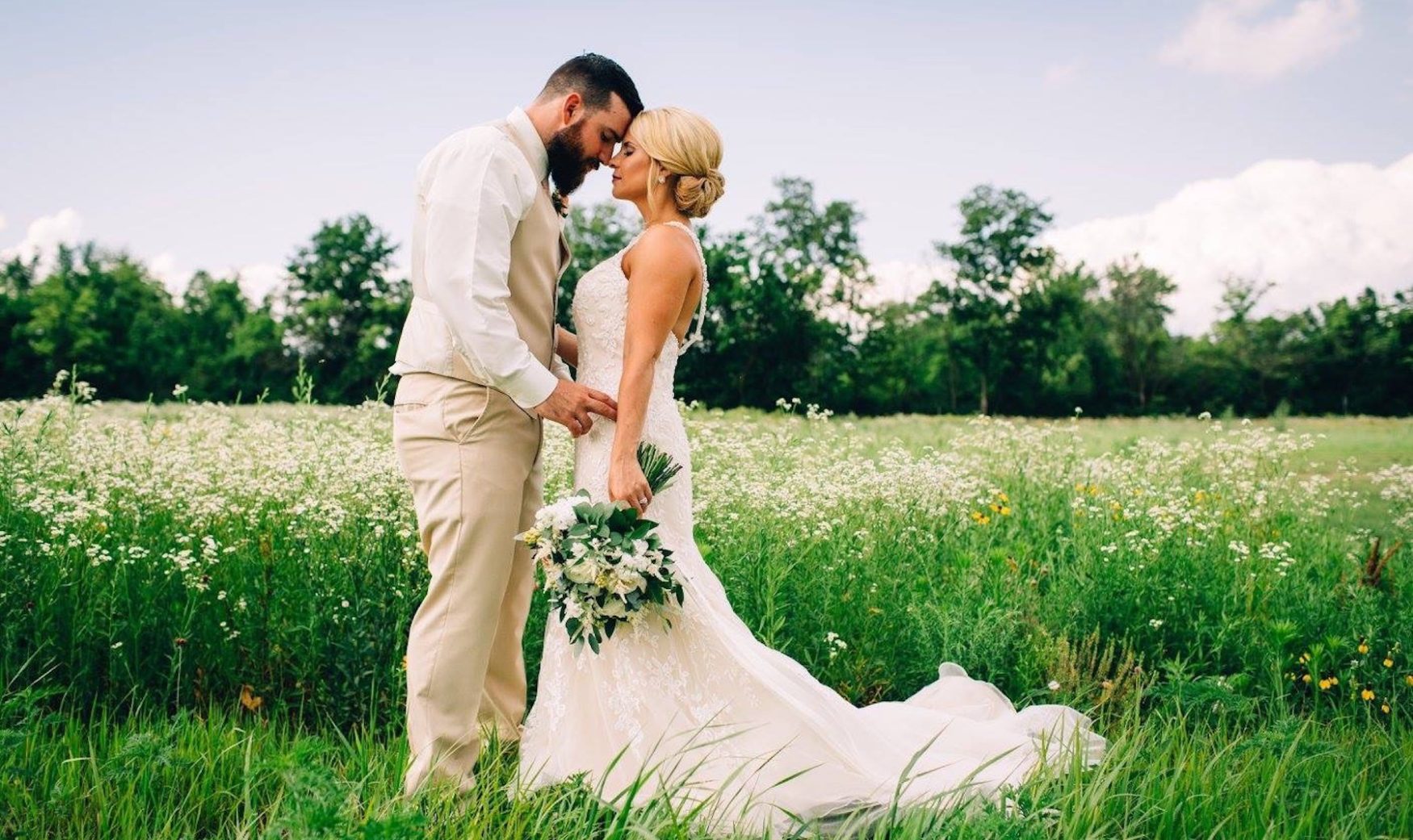 bride and groom posing in ohio wildflower meadow