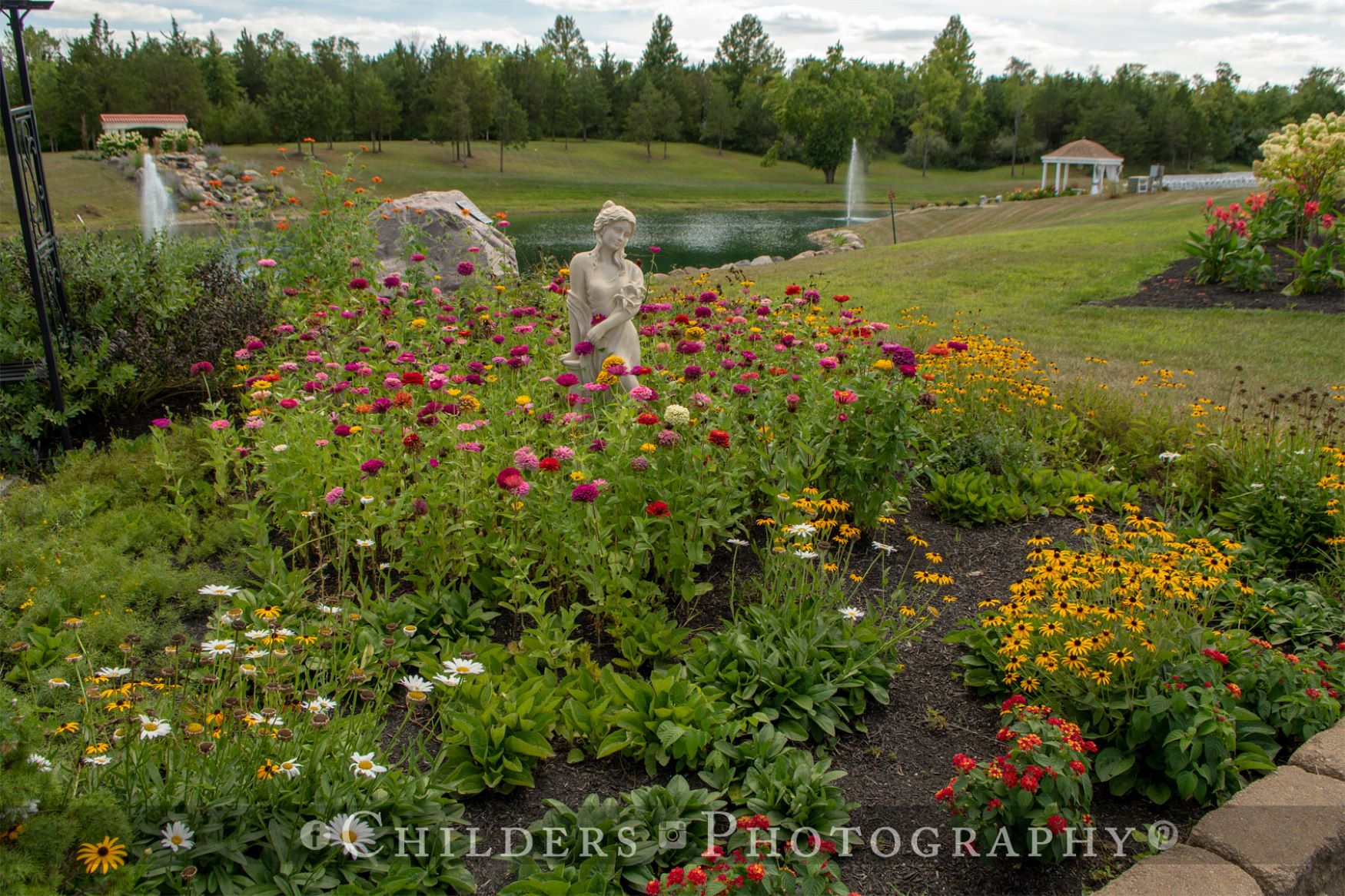 perennial beds with greek statue.