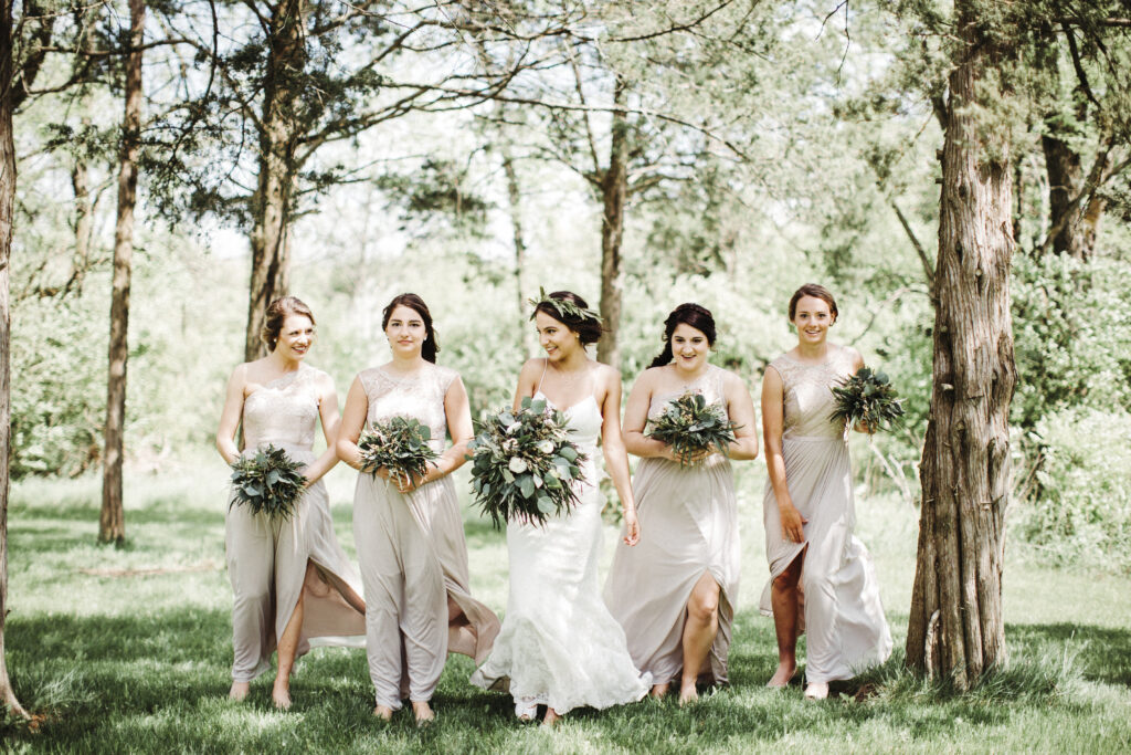 elegant bridal party posing in the forest