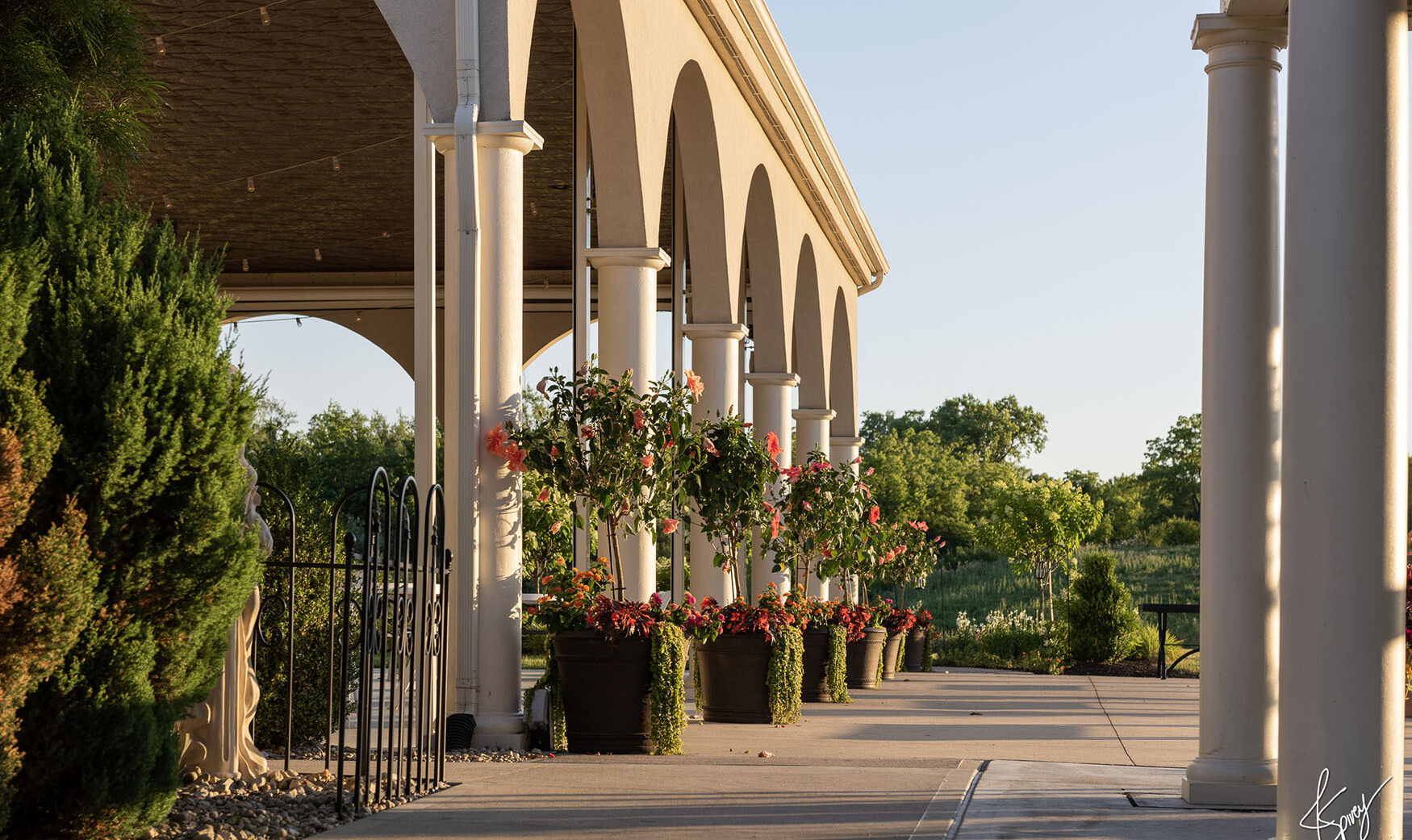 Tuscan style Pavilion with hibiscus in flower pots